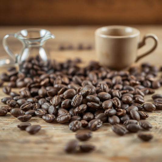 Artisanal coffee beans on wood with a pour-over dripper and cup in soft focus